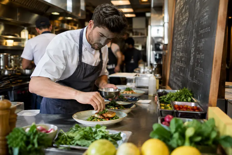 Friends sharing small plates and coffee at a relaxed restaurant table