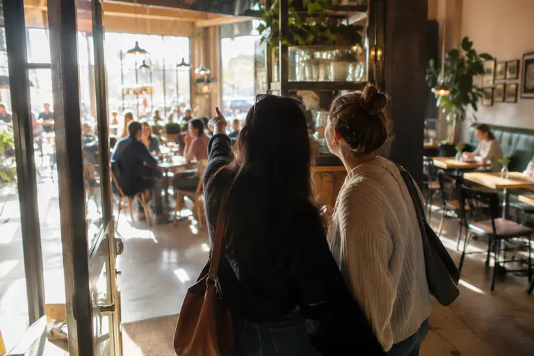Guest looking across a cafe room before choosing a table